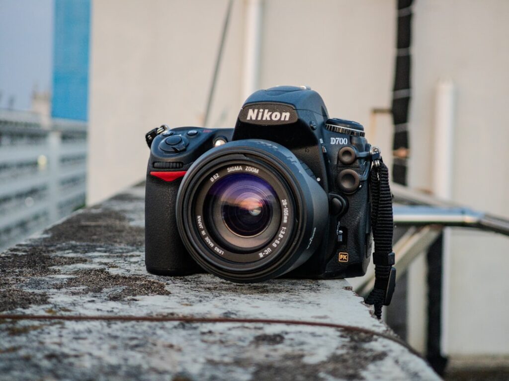 A black nikon camera with a lens.