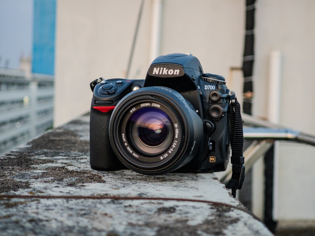 A black nikon camera with a lens.